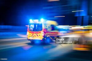 The ambulance circulating the streets at night, close-up, long exposure